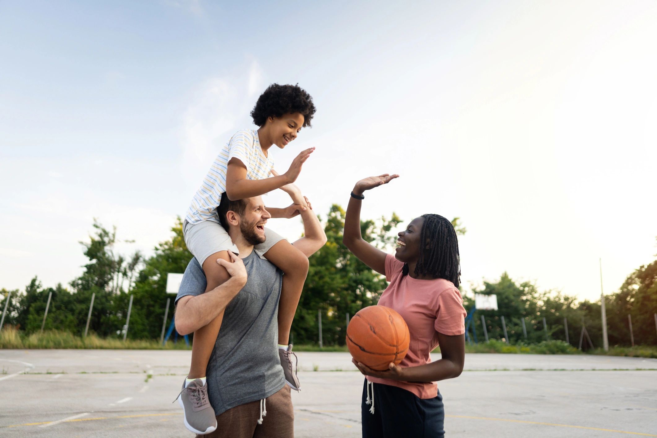 Parent and child celebrating after a basketball game